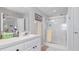 Bright bathroom features a single vanity, neutral walls, and a shower with glass doors at 8461 Buttonquail Dr, Englewood, FL 34224