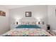 Bright bedroom featuring floral bedding, white furniture, and cozy decor creating a relaxing atmosphere at 8461 Buttonquail Dr, Englewood, FL 34224