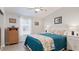 Well-lit bedroom with hardwood floors, a side table, and a queen size bed at 8461 Buttonquail Dr, Englewood, FL 34224