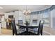 Bright breakfast nook area with dark wood table, seats four, with kitchen in the background at 8461 Buttonquail Dr, Englewood, FL 34224