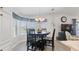 Eat-in dining area with a dark wood table and seating with a view out to the backyard at 8461 Buttonquail Dr, Englewood, FL 34224