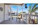 Charming screened front porch with a chair, palm tree, and an American flag on display at 8461 Buttonquail Dr, Englewood, FL 34224