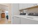 Laundry room with modern front load washer and dryer at 8461 Buttonquail Dr, Englewood, FL 34224