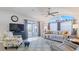 Bright living room featuring vaulted ceilings, modern decor, sliding doors to a porch and a comfortable seating area at 8461 Buttonquail Dr, Englewood, FL 34224