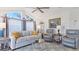 Cozy living room with vaulted ceilings, comfortable seating, and decor; adjacent to the kitchen at 8461 Buttonquail Dr, Englewood, FL 34224