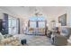 Comfortable living room with vaulted ceilings, lots of natural light, and sliding doors to a screened-in porch at 8461 Buttonquail Dr, Englewood, FL 34224