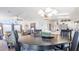 Open concept dining area with the living room and kitchen in the background for easy entertaining at 8461 Buttonquail Dr, Englewood, FL 34224