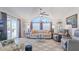 Bright living room features a high ceiling, ceiling fan, and sliding glass doors to the outdoor patio at 8461 Buttonquail Dr, Englewood, FL 34224