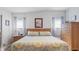 Bright bedroom features neutral walls, two windows, and natural wood furnishings at 8461 Buttonquail Dr, Englewood, FL 34224