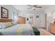 Bright bedroom features neutral walls, a ceiling fan, and an ensuite bathroom at 8461 Buttonquail Dr, Englewood, FL 34224