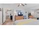 Bright bedroom features neutral walls, a view into other rooms, and a large TV at 8461 Buttonquail Dr, Englewood, FL 34224