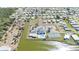 Aerial view of the neighborhood with community center, lake, and surrounding homes at 8461 Buttonquail Dr, Englewood, FL 34224