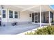 Covered patio area with access to the screened lanai and lush landscaping at 8461 Buttonquail Dr, Englewood, FL 34224