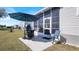 Outdoor patio area with grill, umbrella, and seating, perfect for entertaining at 8461 Buttonquail Dr, Englewood, FL 34224