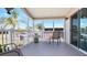 Inviting front porch with comfortable seating and views of the surrounding neighborhood at 8461 Buttonquail Dr, Englewood, FL 34224