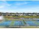 Scenic view of tennis courts, a pond and the surrounding neighborhood in the distance at 8461 Buttonquail Dr, Englewood, FL 34224