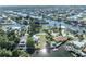 Aerial view showcases waterfront homes, nestled on canals, within a coastal community setting at 3427 Minnow Creek Dr, Hernando Beach, FL 34607