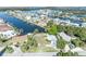 A waterfront neighborhood featuring canal access, lush landscaping, and a yellow home with a metal roof at 3427 Minnow Creek Dr, Hernando Beach, FL 34607