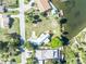 Aerial view of waterfront property, showcasing its unique roofline, boat dock, and neighborhood at 3427 Minnow Creek Dr, Hernando Beach, FL 34607