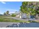 Charming home with a lush front yard, attached garage, and a metal roof, offering both curb appeal and functionality at 3427 Minnow Creek Dr, Hernando Beach, FL 34607