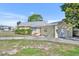 Charming home with a metal roof, showcasing its well-maintained front yard and inviting facade at 3427 Minnow Creek Dr, Hernando Beach, FL 34607
