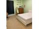 Second bedroom with light green walls, wood dresser, and a desk space at 5271 Visionary Ct, Sarasota, FL 34233