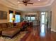 Open-concept living room with hardwood floors and neutral decor, seamlessly connecting to the dining area at 5271 Visionary Ct, Sarasota, FL 34233