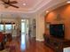 Bright living room with gleaming hardwood floors, open to the kitchen, and dining area at 5271 Visionary Ct, Sarasota, FL 34233