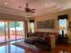 Cozy living room featuring hardwood floors, a ceiling fan, and sliding glass doors to the deck at 5271 Visionary Ct, Sarasota, FL 34233