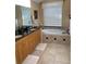 The main bathroom has double sinks, granite countertops, and a jetted tub at 5271 Visionary Ct, Sarasota, FL 34233