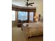 This main bedroom has a ceiling fan, bay window, and upholstered headboard at 5271 Visionary Ct, Sarasota, FL 34233