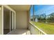 Relaxing screened balcony overlooking a pond with a fountain and lush greenery at 5500 Bentgrass Dr # 6-106, Sarasota, FL 34235