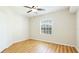 This bedroom features wood-look floors, a bright window, and a ceiling fan at 5500 Bentgrass Dr # 6-106, Sarasota, FL 34235