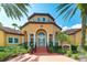 Inviting community center with a tiled roof, arched entryway, and well-maintained landscaping at 5500 Bentgrass Dr # 6-106, Sarasota, FL 34235