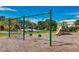 Community playground with swings and a slide surrounded by trees and landscaping with apartment buildings in the background at 5500 Bentgrass Dr # 6-106, Sarasota, FL 34235