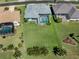 Aerial view of a property with a large backyard, screened-in pool, and mature landscaping at 519 Purslane Pt, Venice, FL 34293