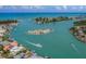 Stunning aerial view of a waterway featuring islands, boats, and waterfront homes at 519 Purslane Pt, Venice, FL 34293