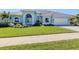 Beautiful one-story home with arched windows, a well-maintained lawn, and a two-car garage at 519 Purslane Pt, Venice, FL 34293
