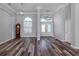 Elegant foyer featuring wood-look flooring, high ceilings, decorative lighting, and a view of the front doors at 519 Purslane Pt, Venice, FL 34293