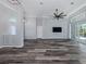 Open living area featuring wood-look floors, a ceiling fan, and a seamless transition to the outdoor space at 519 Purslane Pt, Venice, FL 34293