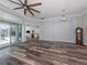 Open living room featuring stylish wood-look flooring, high ceilings, and access to a screened lanai at 519 Purslane Pt, Venice, FL 34293