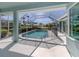 A stunning screened-in pool area with clear blue water and a -safe pool fence at 519 Purslane Pt, Venice, FL 34293