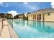 Community pool and lounge area with ample seating and a covered veranda for relaxing by the water at 519 Purslane Pt, Venice, FL 34293