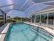 A stunning screened-in pool area with clear blue water and a -safe pool fence at 519 Purslane Pt, Venice, FL 34293