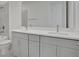 Modern bathroom features a double sink vanity with white countertops and gray cabinets at 192 Eagleston Ln, Lakewood Ranch, FL 34240