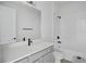 Bathroom features a quartz countertop, white vanity, shower-tub, and neutral tile at 17350 Crisp Apple Ln, Land O Lakes, FL 34638