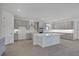 Modern kitchen with stainless appliances, a central island, and neutral cabinets at 17350 Crisp Apple Ln, Land O Lakes, FL 34638