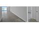 Bright, open-concept living area featuring wood-style flooring and sliding glass doors to water views at 17350 Crisp Apple Ln, Land O Lakes, FL 34638