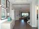 Inviting hallway featuring wood floors, stylish decor, and an open view into the spacious living area at 9558 Brave Buck Ave, Land O Lakes, FL 34638
