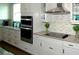 Stylish kitchen with modern appliances, ample counter space, and sleek white cabinetry, perfect for cooking at 9558 Brave Buck Ave, Land O Lakes, FL 34638